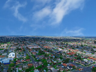 Panoramic aerial Drone view of Melbournes suburbs and CBD looking down at Houses roads and Parks Victoria Australia. Beautiful colours at Sunset