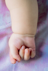 3 month old baby holding hands 