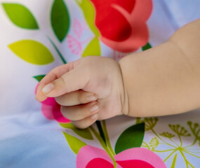 3 month old baby holding hands 