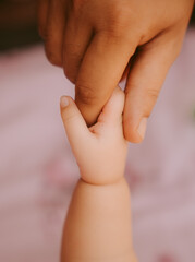 3 month old baby holding hands 