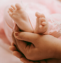 baby feet in a hand