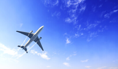 Horizontal nature background with aircraft and Jet trailing smoke in the sky. Airplane and condensation trail