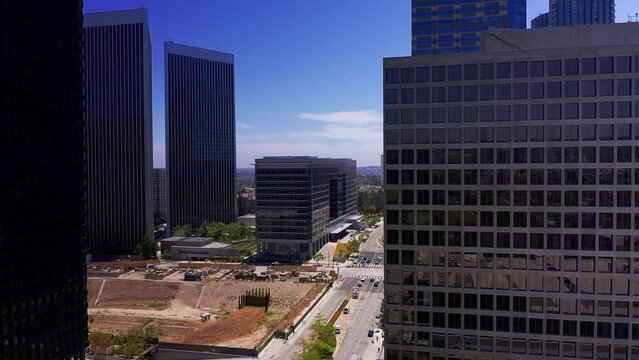 Aerial descending shot flying through the skyscrapers in Century City, California. HD at 60 FPS