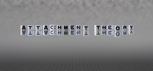attachment theory word or concept represented by black and white letter cubes on a grey horizon background stretching to infinity - obrazy, fototapety, plakaty