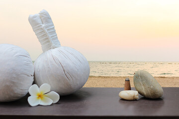 Thai herbal compress ball isolated from beach background. Thai Spa massage. Healthy Concept.