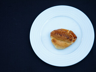 Traditional turkish bun pastry product , tasty pogaca with cheese filling on white plate, top view