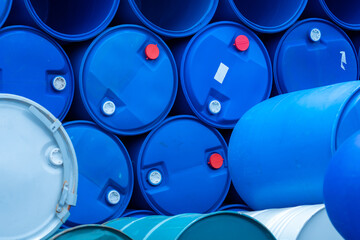 Old chemical barrels. Empty blue chemical drums stack. Steel and plastic oil tank. Toxic waste...