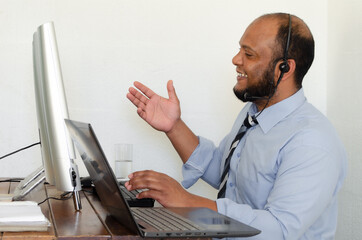 Business man discussing online to clients via skyping/video calling.