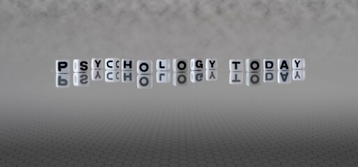 psychology today word or concept represented by black and white letter cubes on a grey horizon...