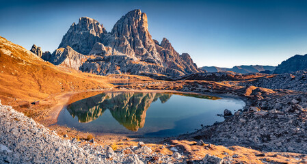 Schusterplatte peak reflected in the Calm waters of Piani lake. Sunny autumn view of Dolomite alps....