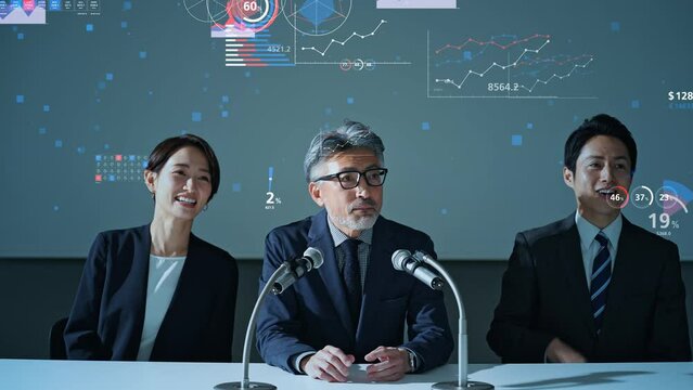 記者会見する人々と統計データ