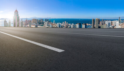 Fototapeta premium Empty road and city buildings background