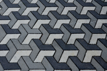 concrete paving with geometric shapes and shades of gray creates a three-dimensional impression of the space. unpleasant for people suffering from dizziness and disorientation