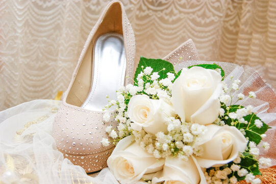 Wedding photo, shoes and wedding bouquet beige roses green leaves