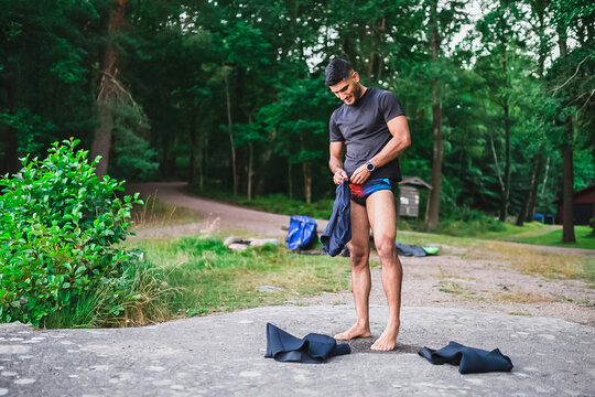 Man Putting On Swimming Trunks