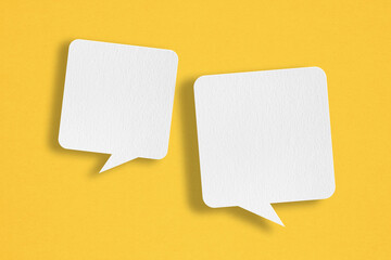 two blank white speech bubble   paper cut,  on grunge yellow paper background. Conceptual image about communication and social media - obrazy, fototapety, plakaty