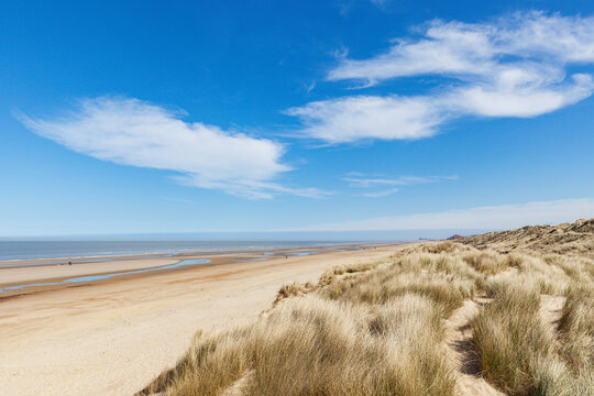 Belgium, West Flanders,De Haan, Clouds over grassy dunes