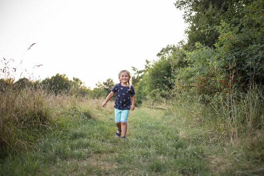 Smiling girl walking on meadow