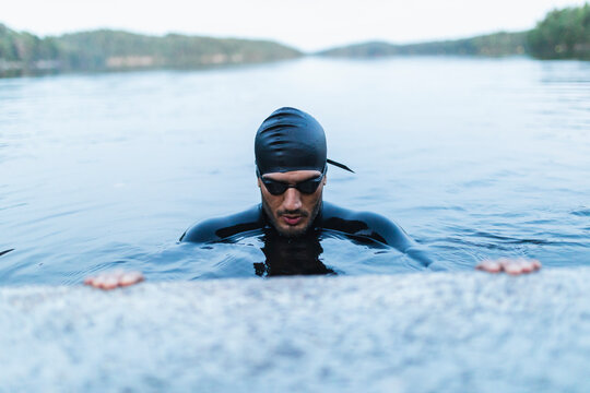 Man taking break swimming in lake