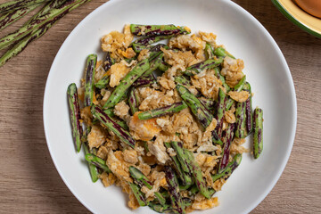 Stir fried Yardlong bean with eggs on wooden background