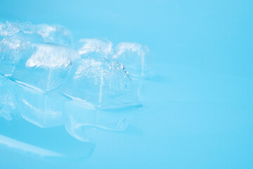clear frost ice cubes on blue background