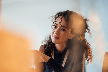 Smiling thoughtful young engineer with semiconductor at office