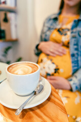 Pregnant woman drink coffee. Lifestyle morning with happy pregnancy girl drink espresso coffee....