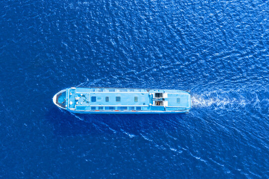 Small Passenger Ferry Boat Floats In Sea Waters, A View From A Height Exactly From Above.