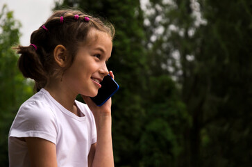 Fototapeta premium The child communicates on the phone