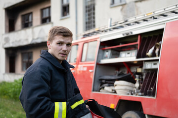 depressed and tired firefighter near fire truck. 