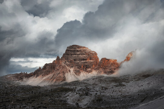 Mystical beautiful mountain landscape with thunder clouds and fog in cloudy weather. Tre Cime park in Dolomites, Italy. Italian alps