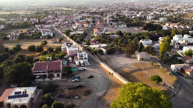 Aerial drone fly over footage of medieval castle of Kolossi, situated in the south of Cyprus, in Limassol and village settlement from above. The castle dates back to the crusades and it is a landmark.