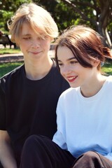 Obraz premium A young couple of teenagers are happy together and want love. First kiss. Girl in a cap