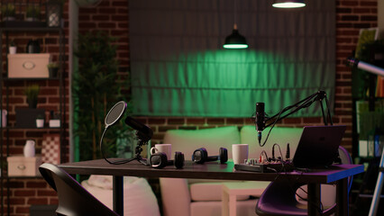 Nobody in cozy ambient room with podcast equipment, microphone and headphones for interview...