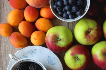Various healthy seasonal food arranged on wooden background. Flat lay.