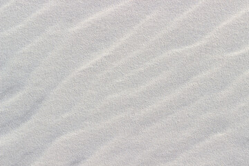 Fototapeta na wymiar wavy white sand closeup used as background