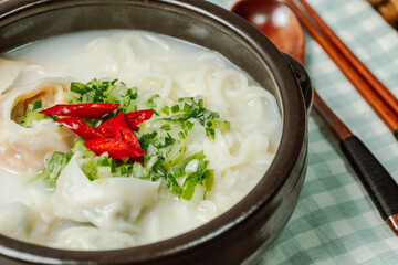 Korean style noodle soup with dumplings, mandu kalguksu