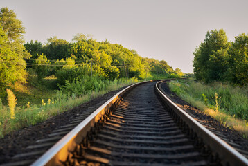 Fototapeta na wymiar A railroad crossing the horizon at sunset