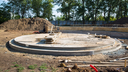 Construction of a round stage stage for performances, pouring foundation with concrete.
