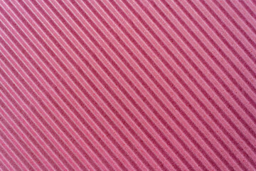 Pink color design of corrugated paper, cardboard. The template for placement of text. Blurred close-up. Also can be used as background and example of texture
