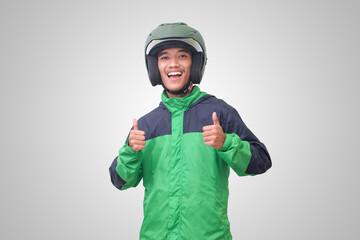Portrait of Asian online taxi driver wearing green jacket and helmet showing good job sign, thumb up. Isolated image on white background