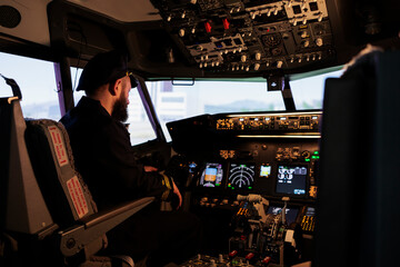 Caucasian plane captain getting ready to takeoff and fly airplane using control command and power...