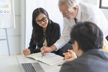 Business coach explaining strategy to young entrepreneur for startup business plan.