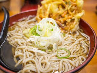 closed up japanese soba noodle and fried vegetable in a big bowl on the table