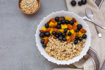 Bowl of oatmeal porridge with fresh fruits