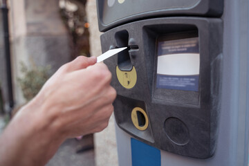 Close up of a hand inserting a card to atm