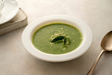 Spinach soup. Green creamy, vegan creamy soup on bright background