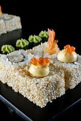 white sushi rolls with list on black background 