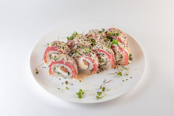 red sushi on a plate with souse