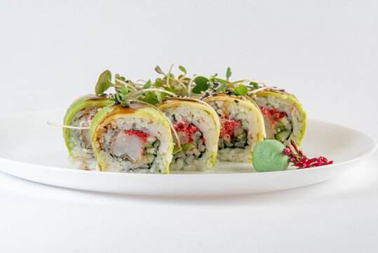 green sushi on a plate with vasabi